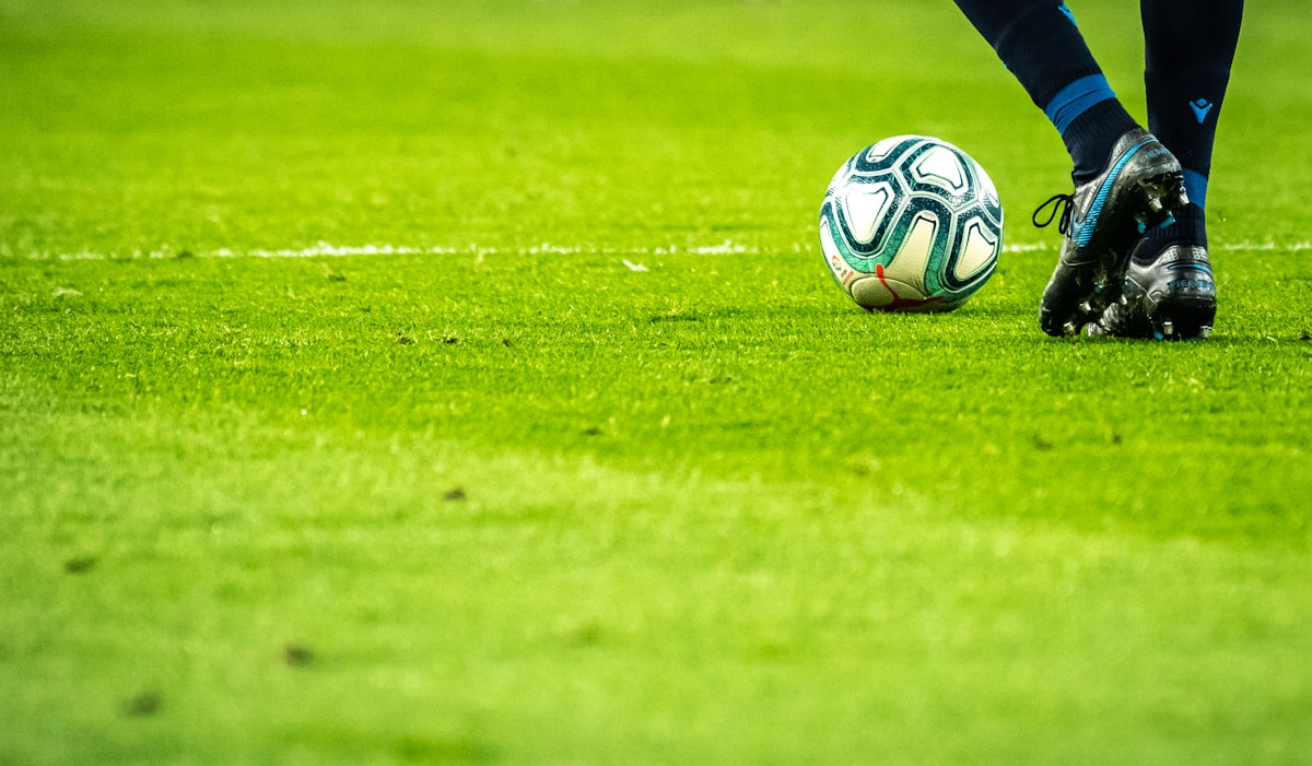Soccer ball on pitch - Unsplash License